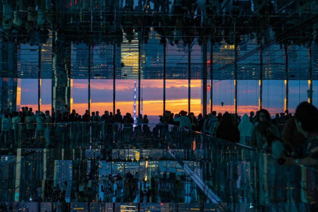 Visitors silhouetted against sunset at SUMMIT