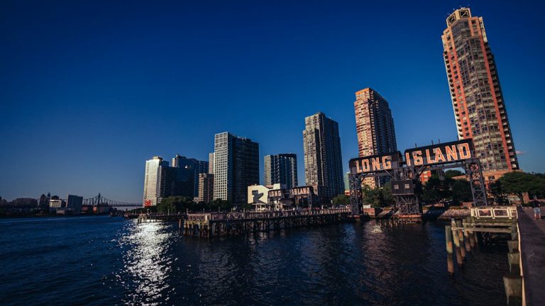 Illuminated Long Island gantries beside the Long Island City waterfront