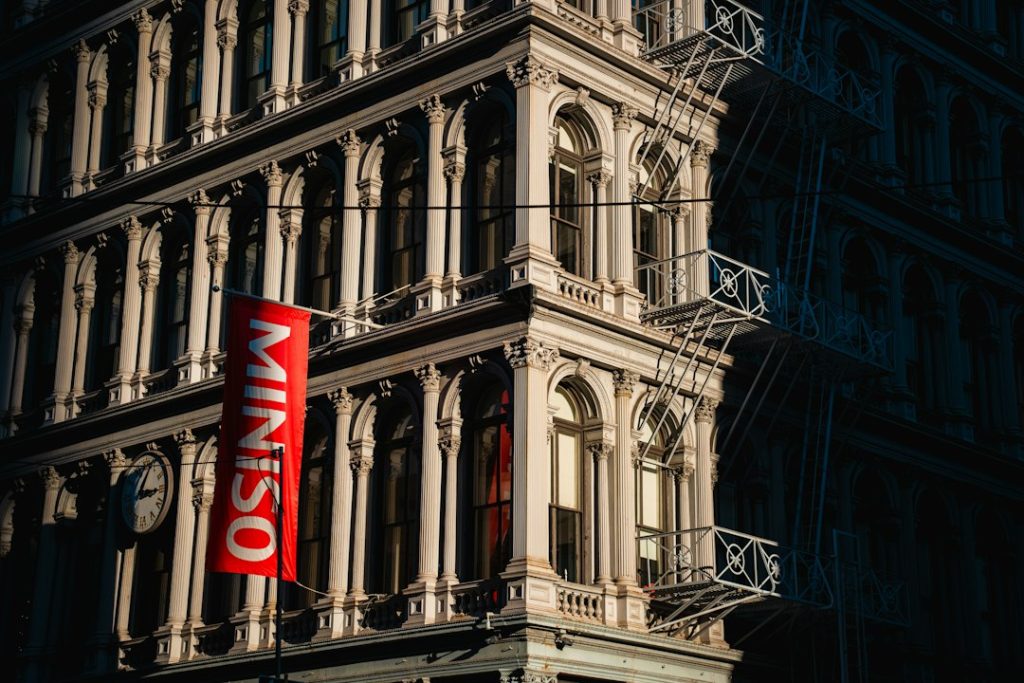 Sunlit cast-iron columns, windows and a clock in SoHo