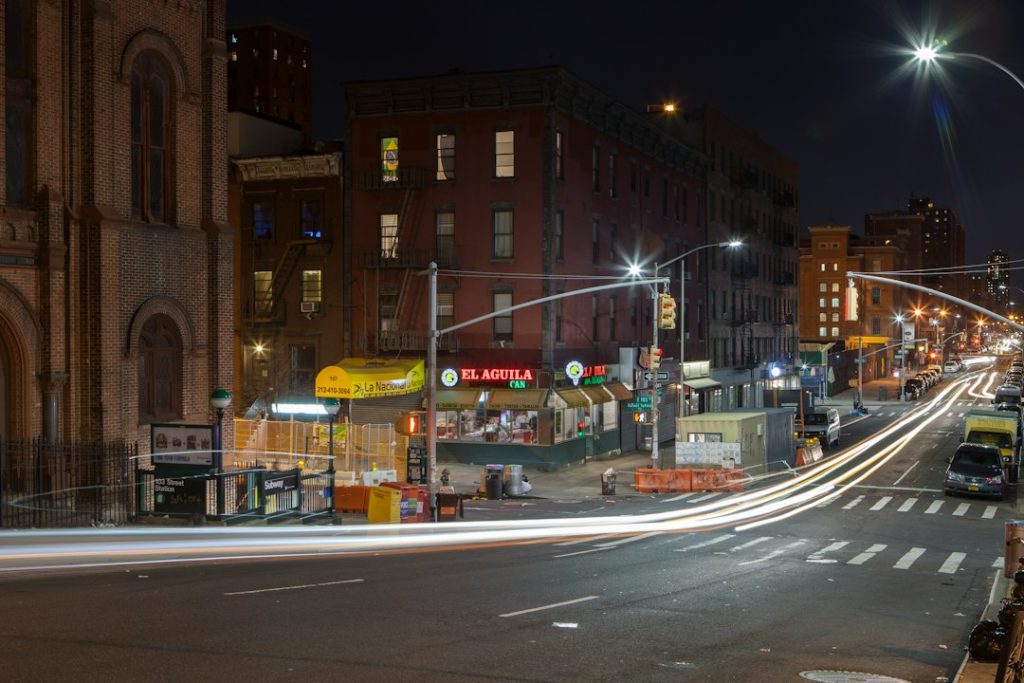 Harlem storefronts and traffic lights at night