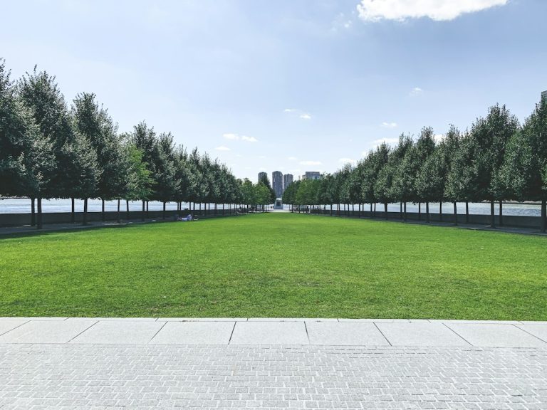 Tree-lined lawn leading toward the monument at Four Freedoms Park