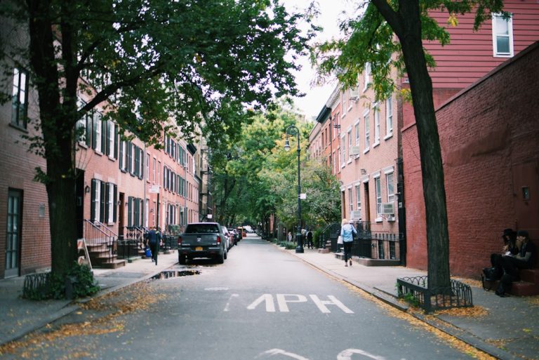 Trees and brick buildings along a West Village street