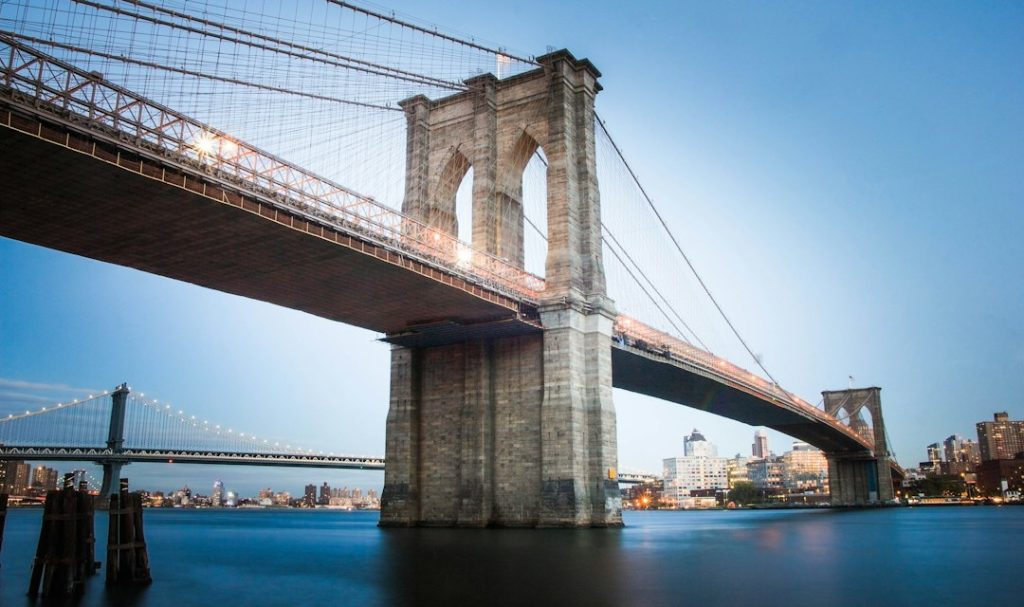 Brooklyn Bridge spanning the East River, seen from the waterfront
