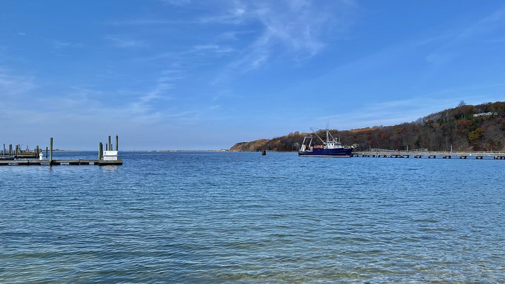 Blue water, docks and a research vessel in Port Jefferson Harbor