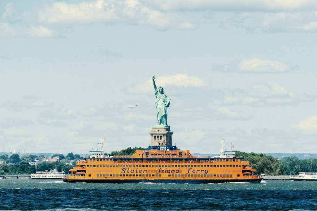 A Staten Island Ferry passing the Statue of Liberty