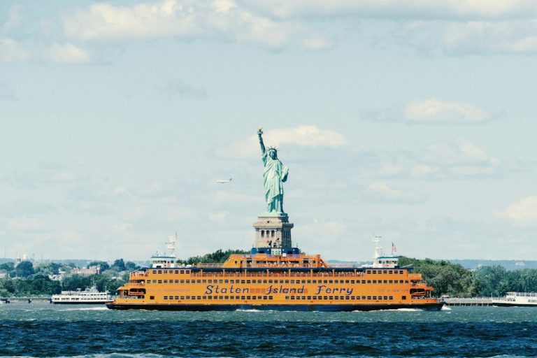 A Staten Island Ferry passing the Statue of Liberty
