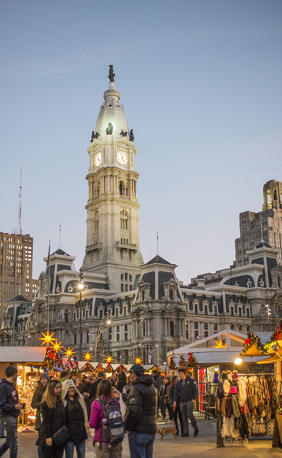 Christmas Village market stalls with Philadelphia City Hall behind them