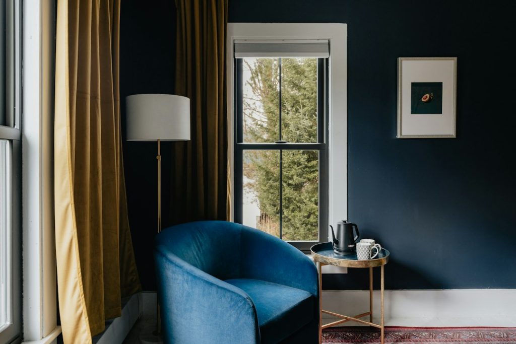 Blue armchair beside a window in a room
