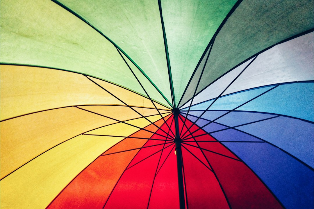 A close view of a rainbow-colored umbrella canopy