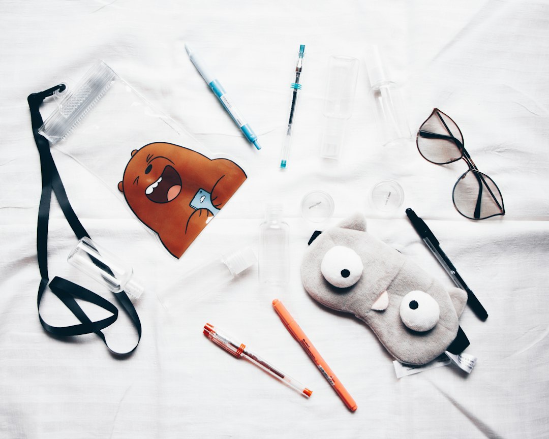 Sunglasses and small fabric accessories arranged on a light background
