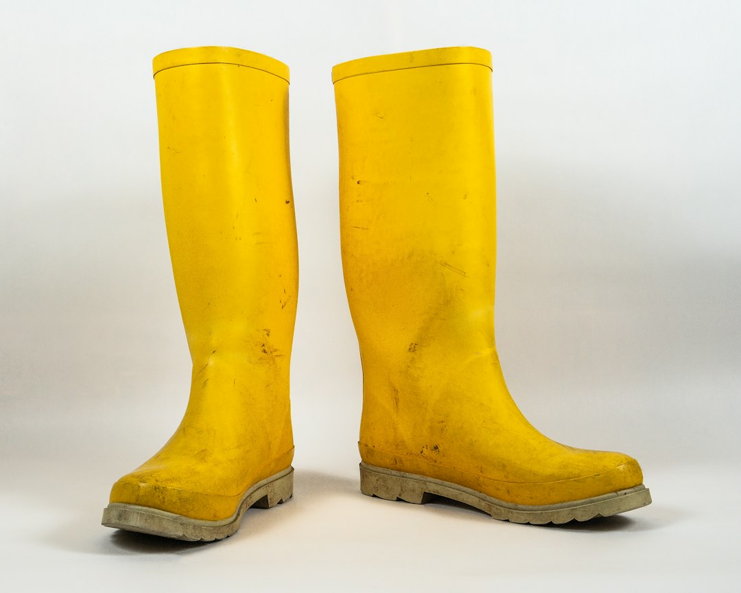 Yellow rain boots against a light background; footwear category inspiration