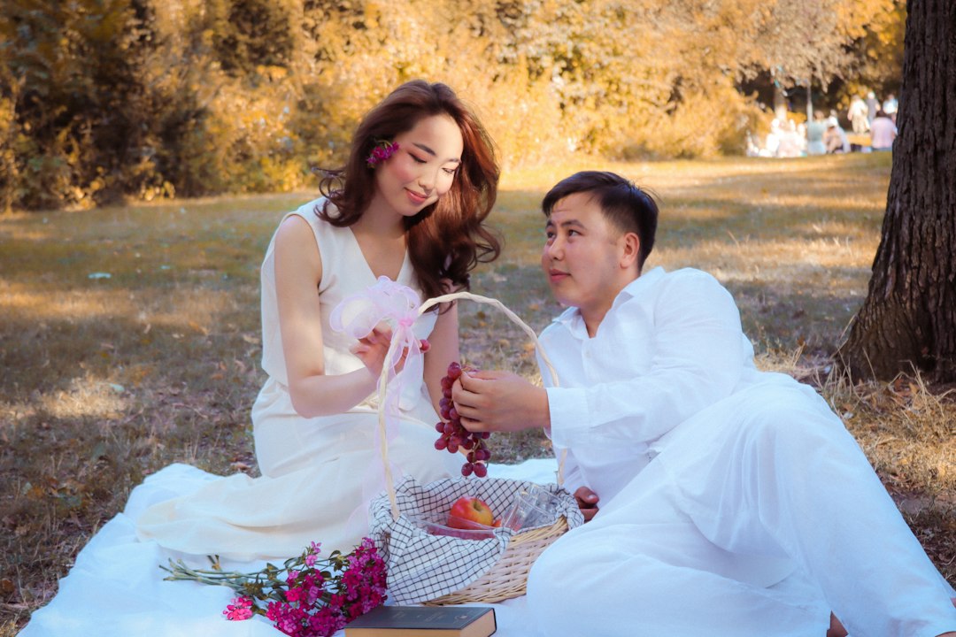 Two people enjoying a picnic beneath a tree; lifestyle inspiration
