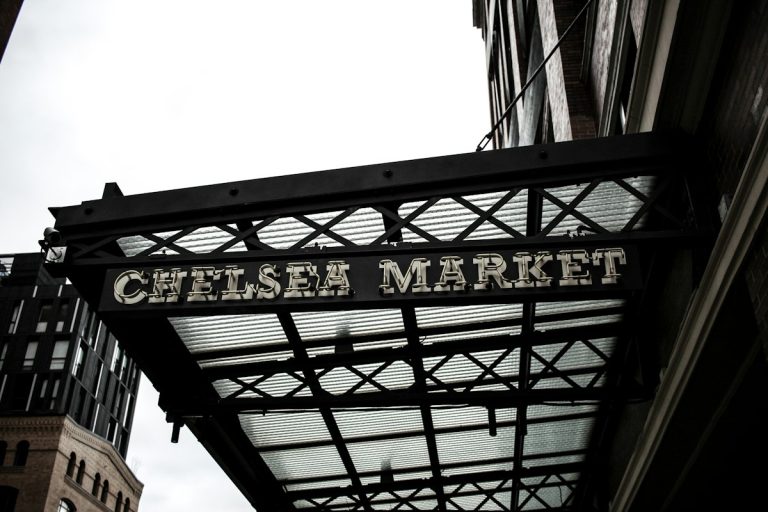 Chelsea Market sign hanging on the brick exterior in Manhattan