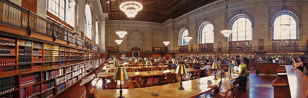 Readers at long tables in a grand New York Public Library reading room