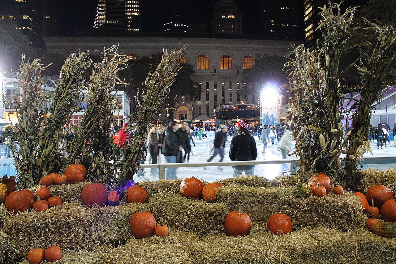 Skaters and seasonal decorations beside the Bryant Park ice rink