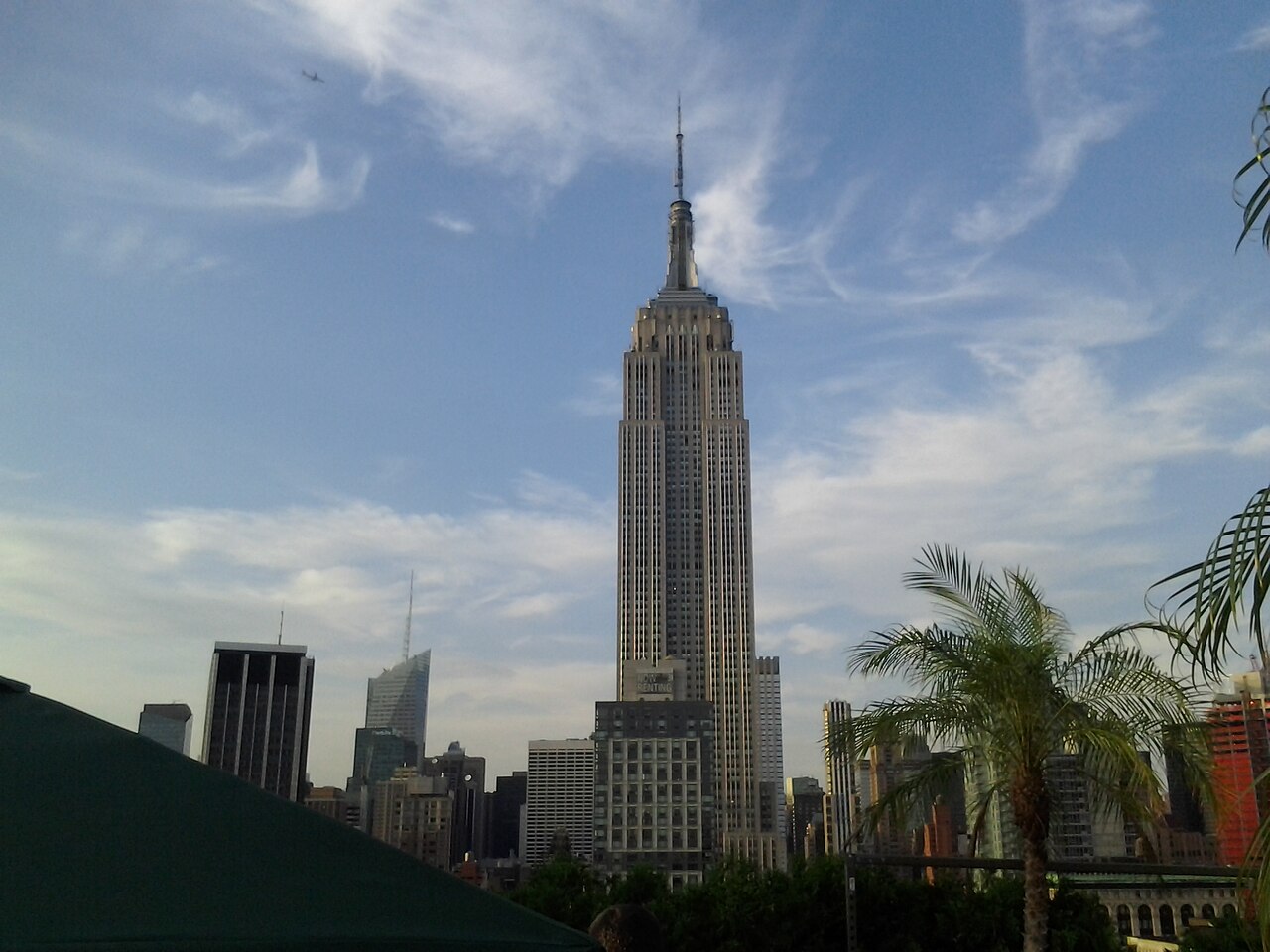 Empire State Building seen above a planted rooftop at 230 Fifth